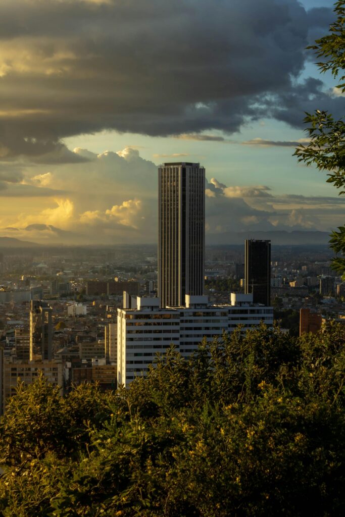 Skyscraper against a dramatic sky in a vibrant cityscape, ideal for urban stock photography.