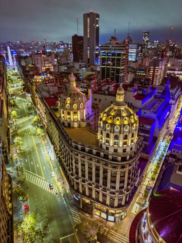 Stunning aerial night view of bustling Buenos Aires cityscape featuring iconic architecture and vibrant streets.