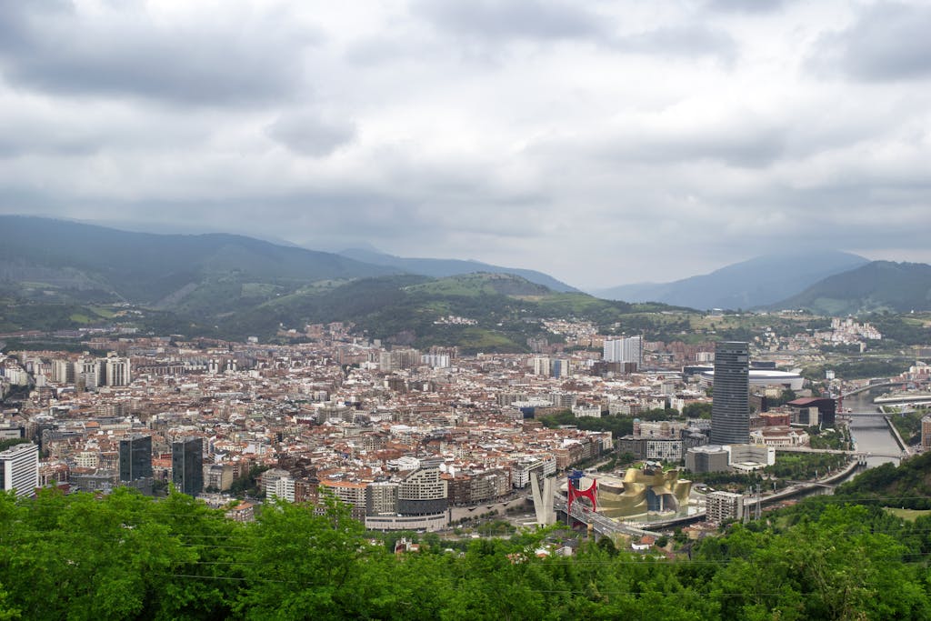 Aerial view of Bilbao, Spain featuring the Guggenheim Museum and surrounding urban landscape.