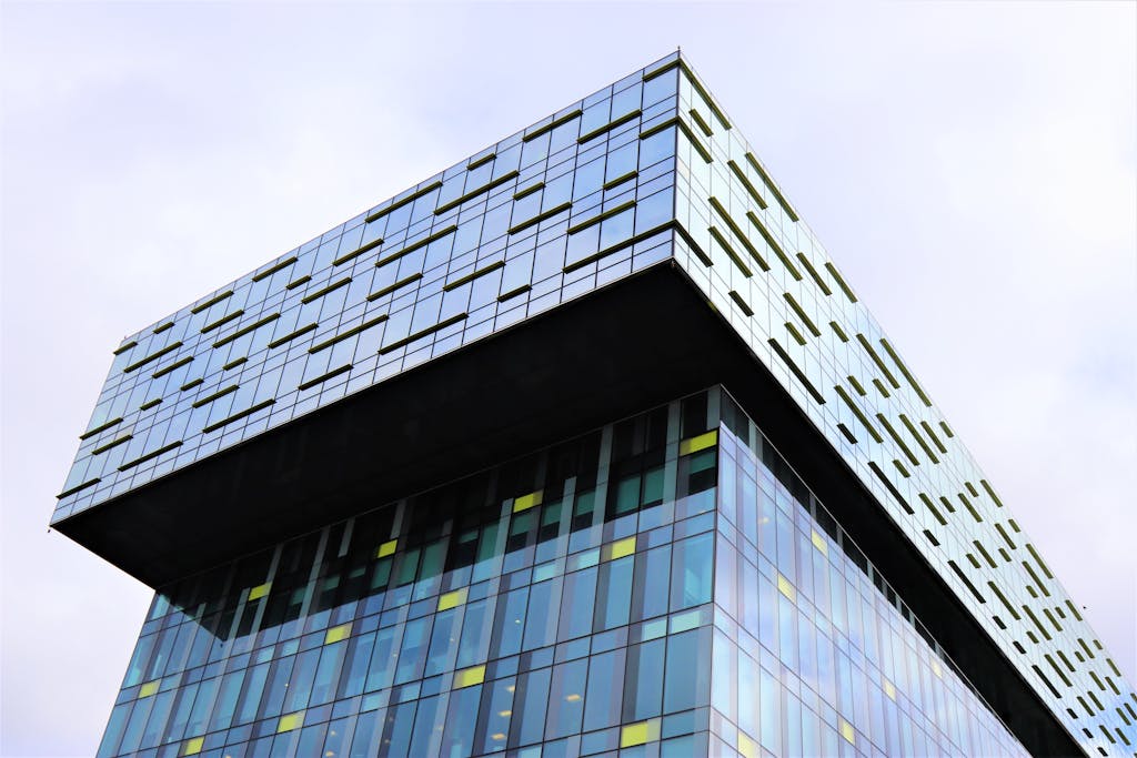 A striking modern skyscraper with a unique floating cube design and glass facade.